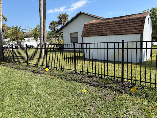 Black aluminum fence around a backyard