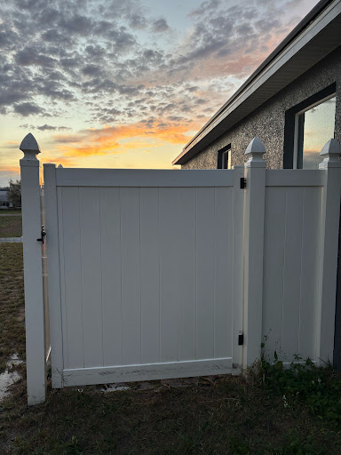 Gray vinyl gate installed beside a home
